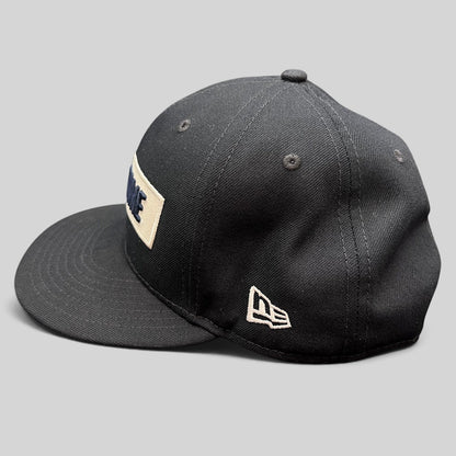 Raree Finds black New Era 9FIFTY Notre Dame snapback hat with a cream rectangular wordmark patch and flat brim.