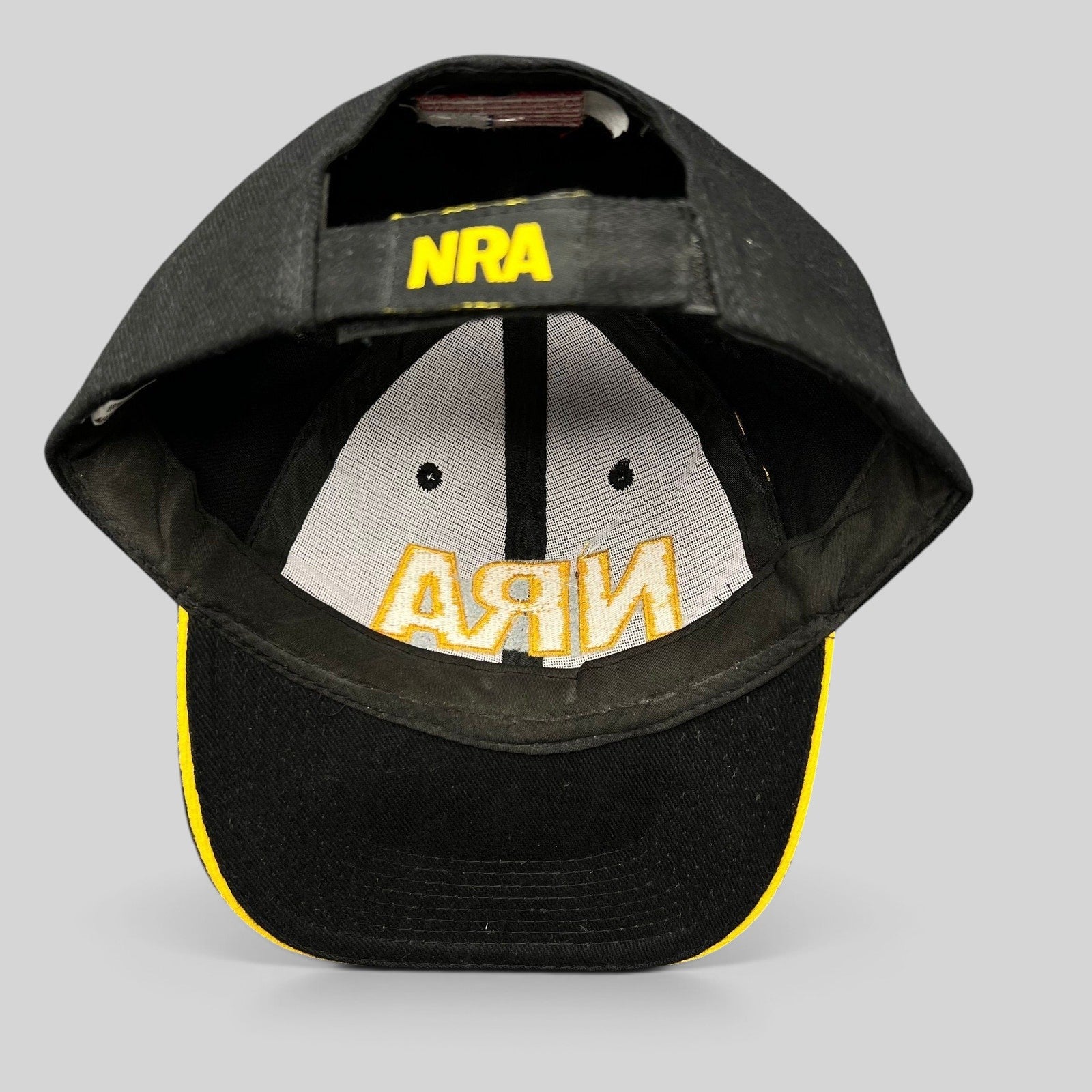 Raree Finds black and yellow NRA strapback hat with embroidered logo on the adjustable back strap