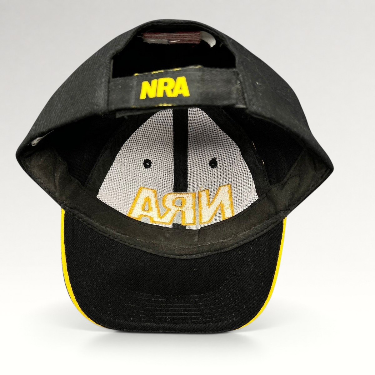 Raree Finds black and yellow NRA strapback hat with embroidered logo on the adjustable back strap