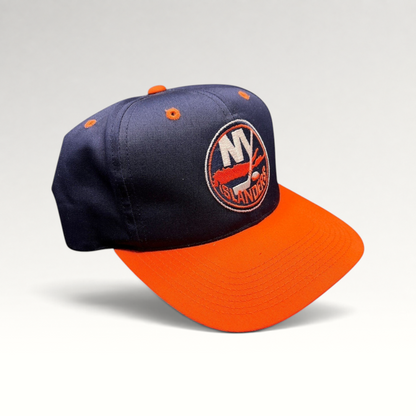 Raree Finds vintage 1990s New York Islanders snapback hat in navy and orange with embroidered team logo and green brim.