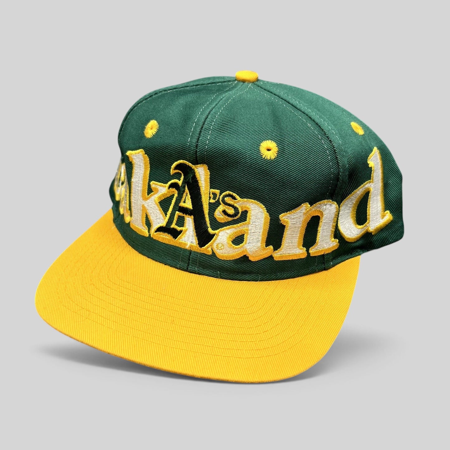 Raree Finds vintage 90s Oakland Athletics snapback hat with oversized green and yellow script embroidery