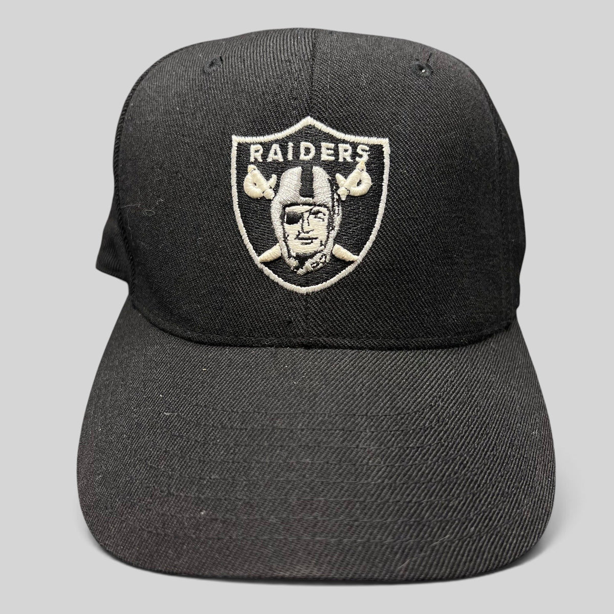 Raree Finds vintage Reebok Oakland Raiders black wool blend fitted hat with silver shield logo embroidery