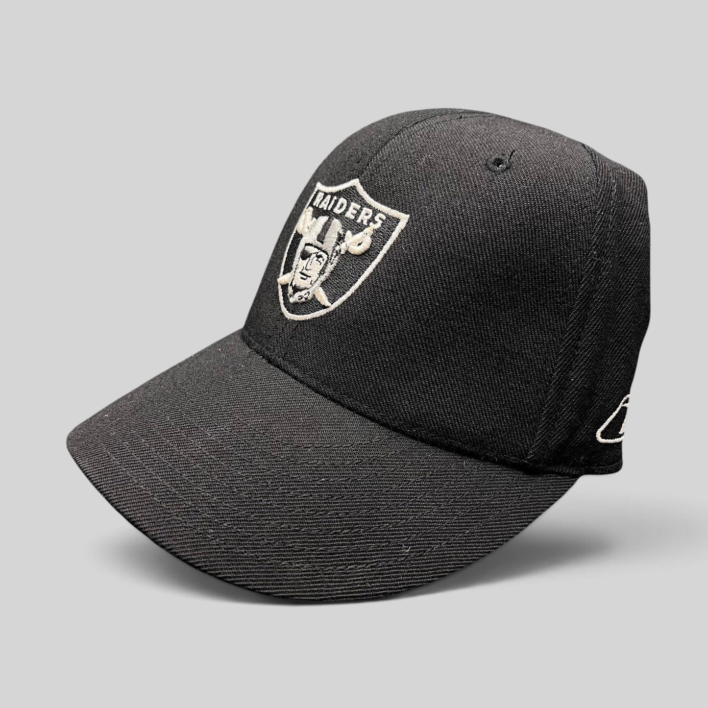 Raree Finds vintage Oakland Raiders Reebok fitted hat in black wool blend with silver embroidered shield logo