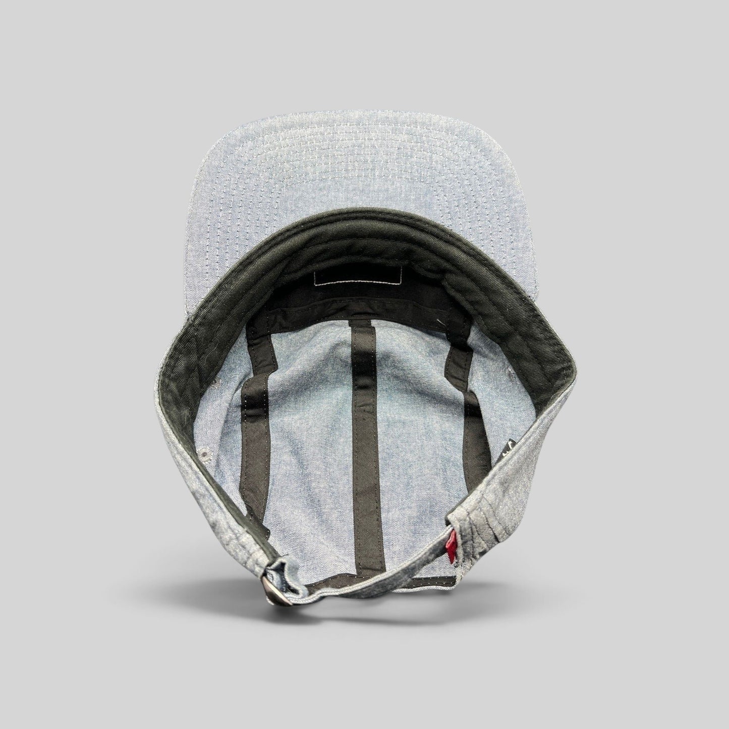 Raree Finds Oakley light denim chambray 5-panel cap interior view showing black taping and adjustable metal buckle