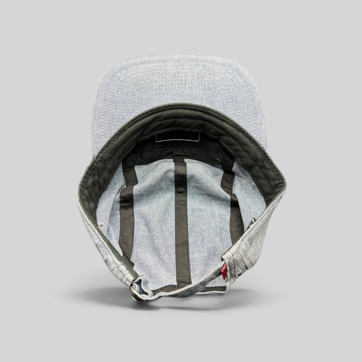 Raree Finds Oakley light denim chambray 5-panel cap interior view showing black taping and adjustable metal buckle