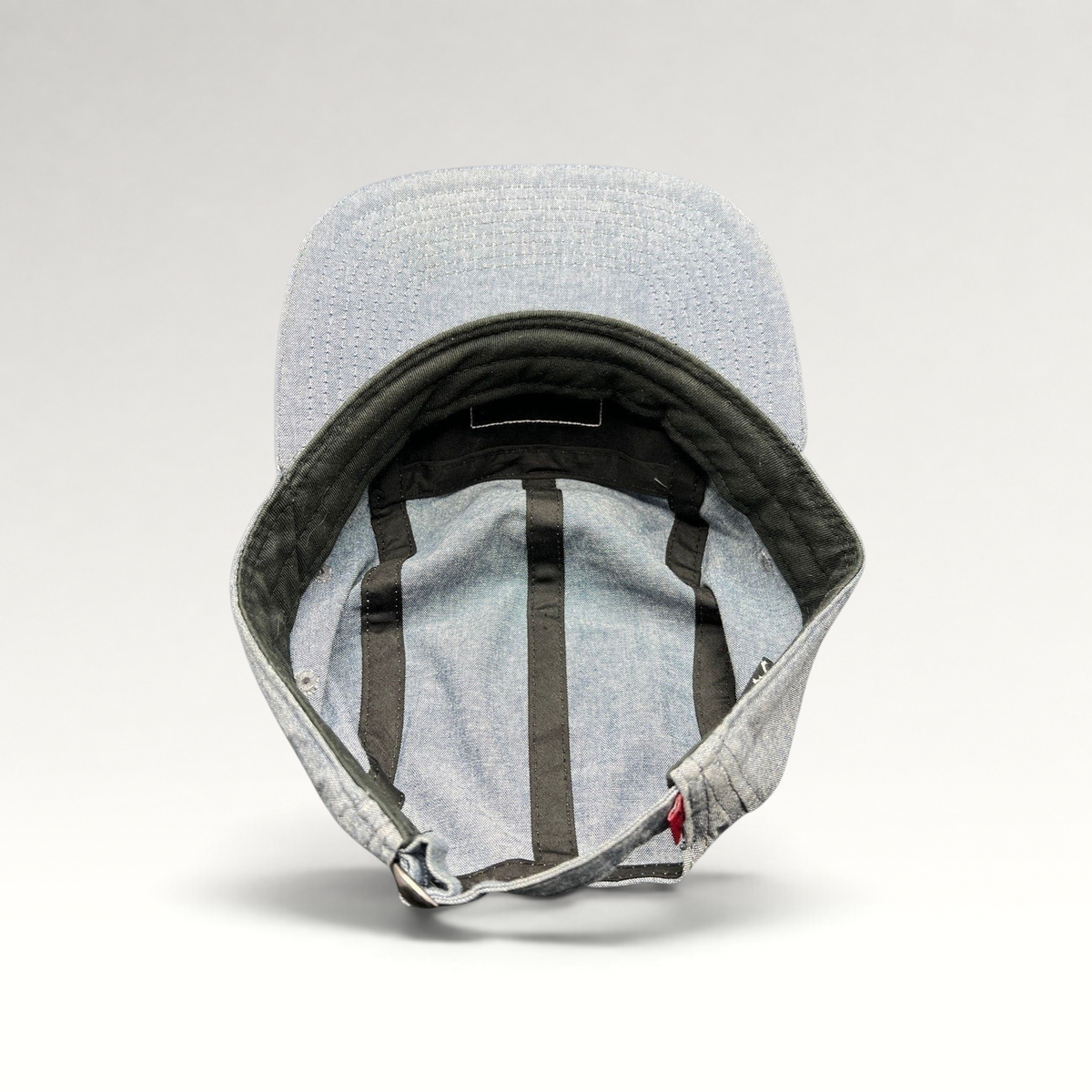 Raree Finds Oakley light denim chambray 5-panel cap interior view showing black taping and adjustable metal buckle