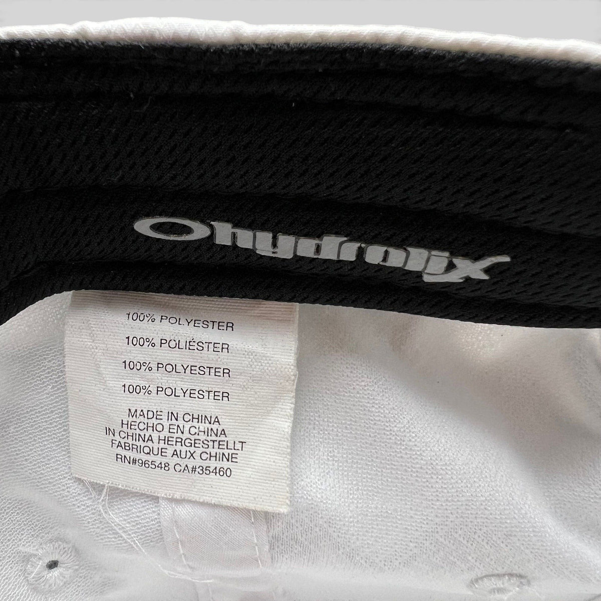 Raree Finds Oakley Hydrolix performance hat interior tag showing 100 percent polyester material and branding