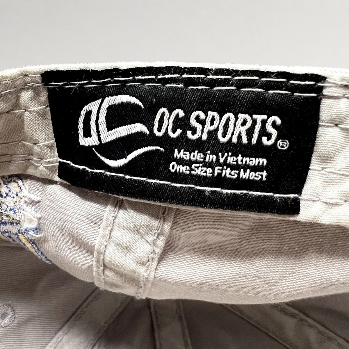 Raree Finds OC Sports branded interior label on a cream cotton baseball cap with Made in Vietnam text