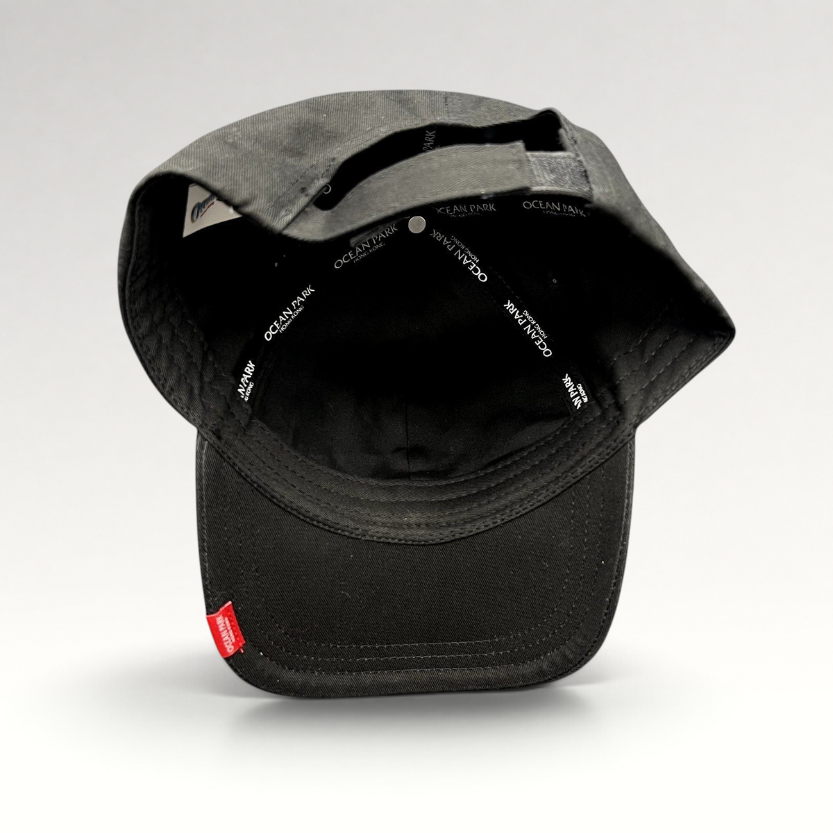 Raree Finds black strapback cap from Ocean Park Hong Kong featuring interior branded taping and a small red logo tag