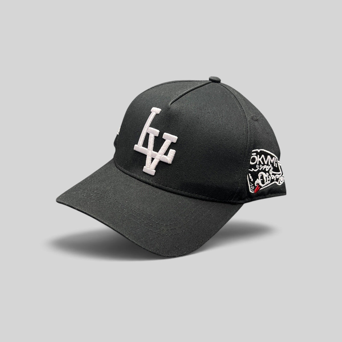 Raree Finds black Okami Brand strapback hat with white embroidered LV logo and side wolf-themed graphic artwork