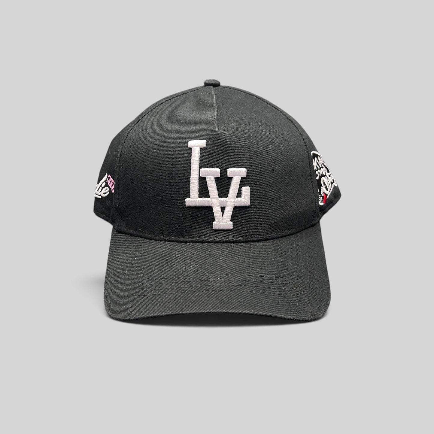 Raree Finds black Okami Brand strapback hat with white embroidered LV logo and detailed side panel artwork