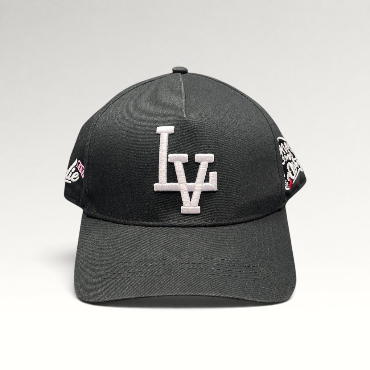 Raree Finds black Okami Brand strapback hat with white embroidered LV logo and detailed side panel artwork