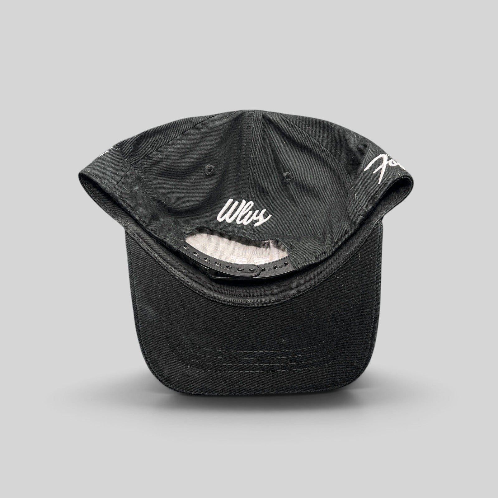 Raree Finds black Okami Brand strapback hat with white Wlvs script embroidery on the back and adjustable strap closure