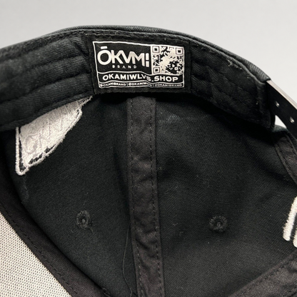 Raree Finds black Okami Brand strapback hat interior showing authentic branded label with QR code and taping