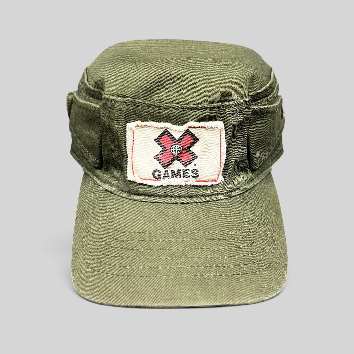 Raree Finds vintage olive green cotton cadet military cap with a distressed X Games patch on the front