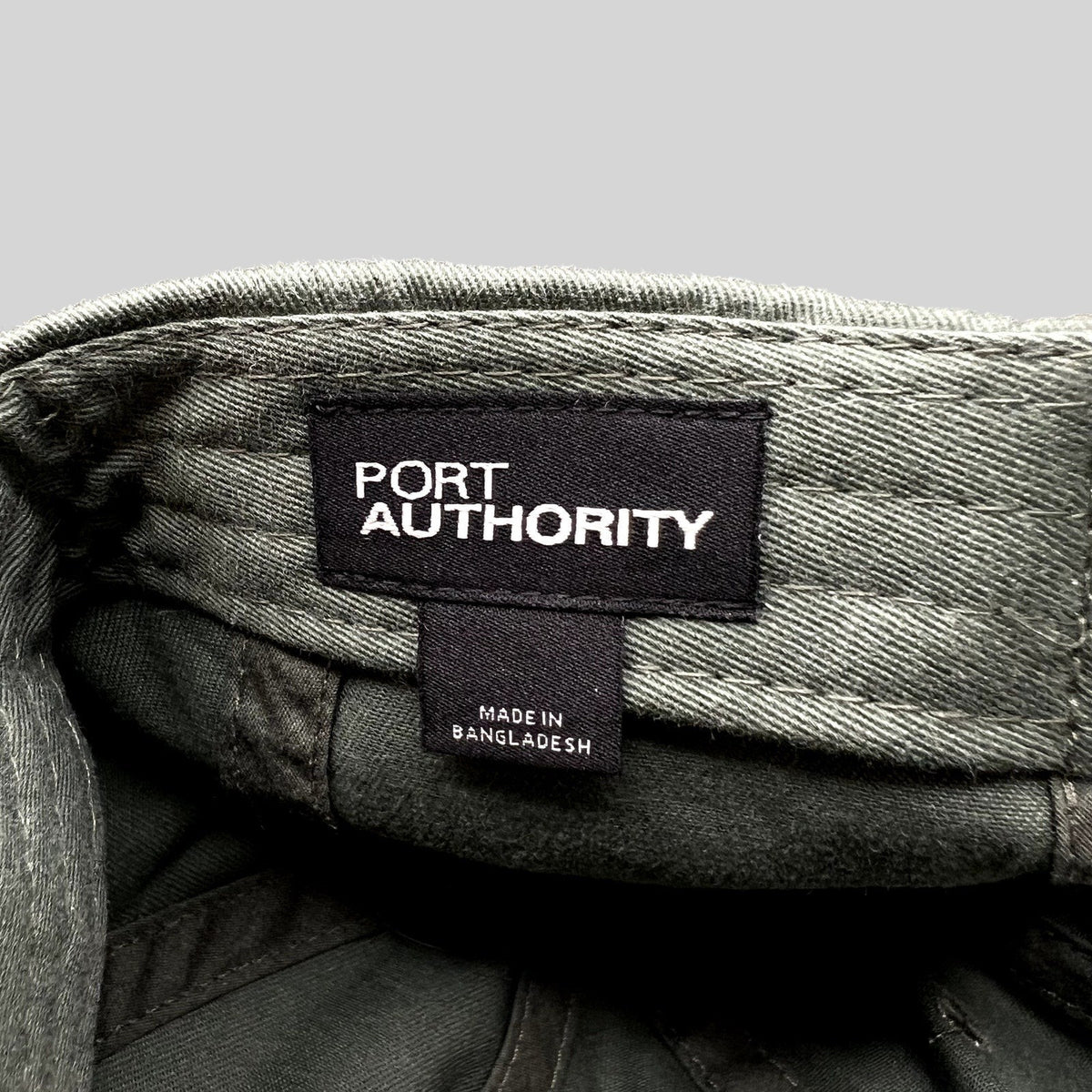 Raree Finds olive green cotton hat interior showing the Port Authority brand label and Made in Bangladesh tag