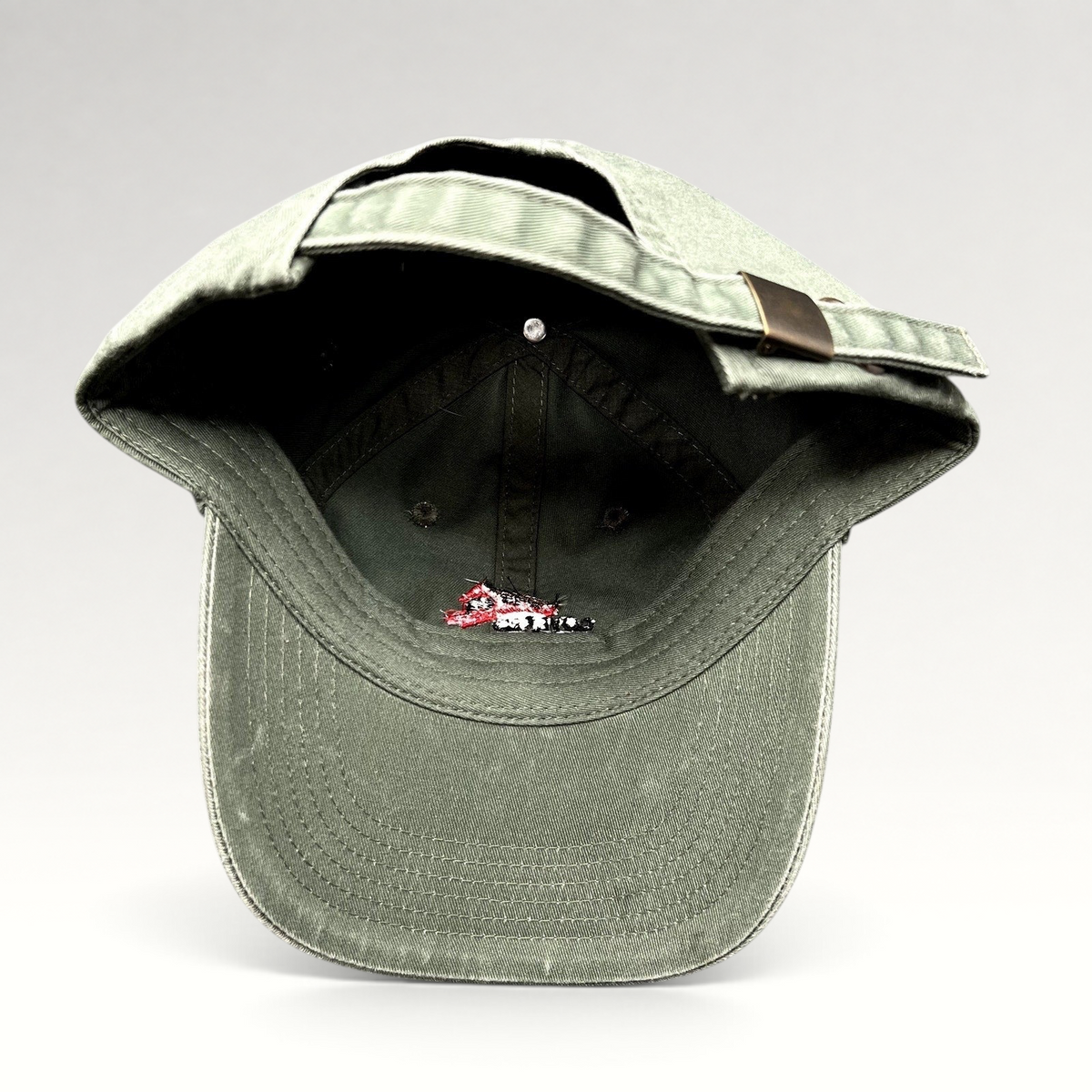 Raree Finds olive green cotton strapback hat with Covered Bridge Recording logo, featuring a brass-tone buckle.