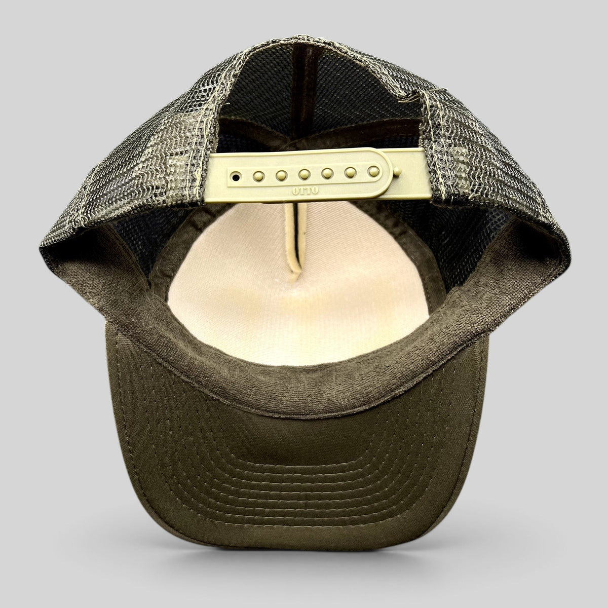 Raree Finds olive green trucker hat with mesh back and adjustable snap closure, interior view showing OTTO branding.