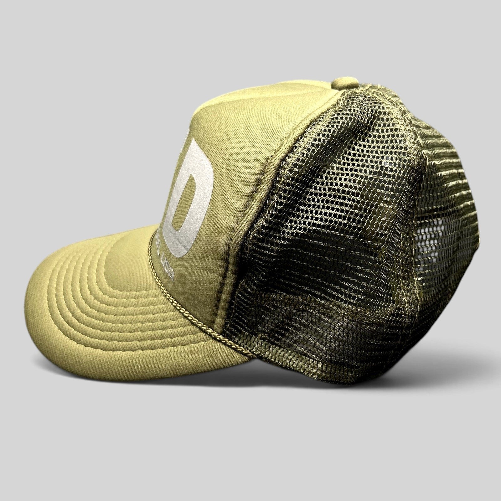 Raree Finds olive green LTD Aspen USA trucker hat with reflective graphic and mesh back, side view.
