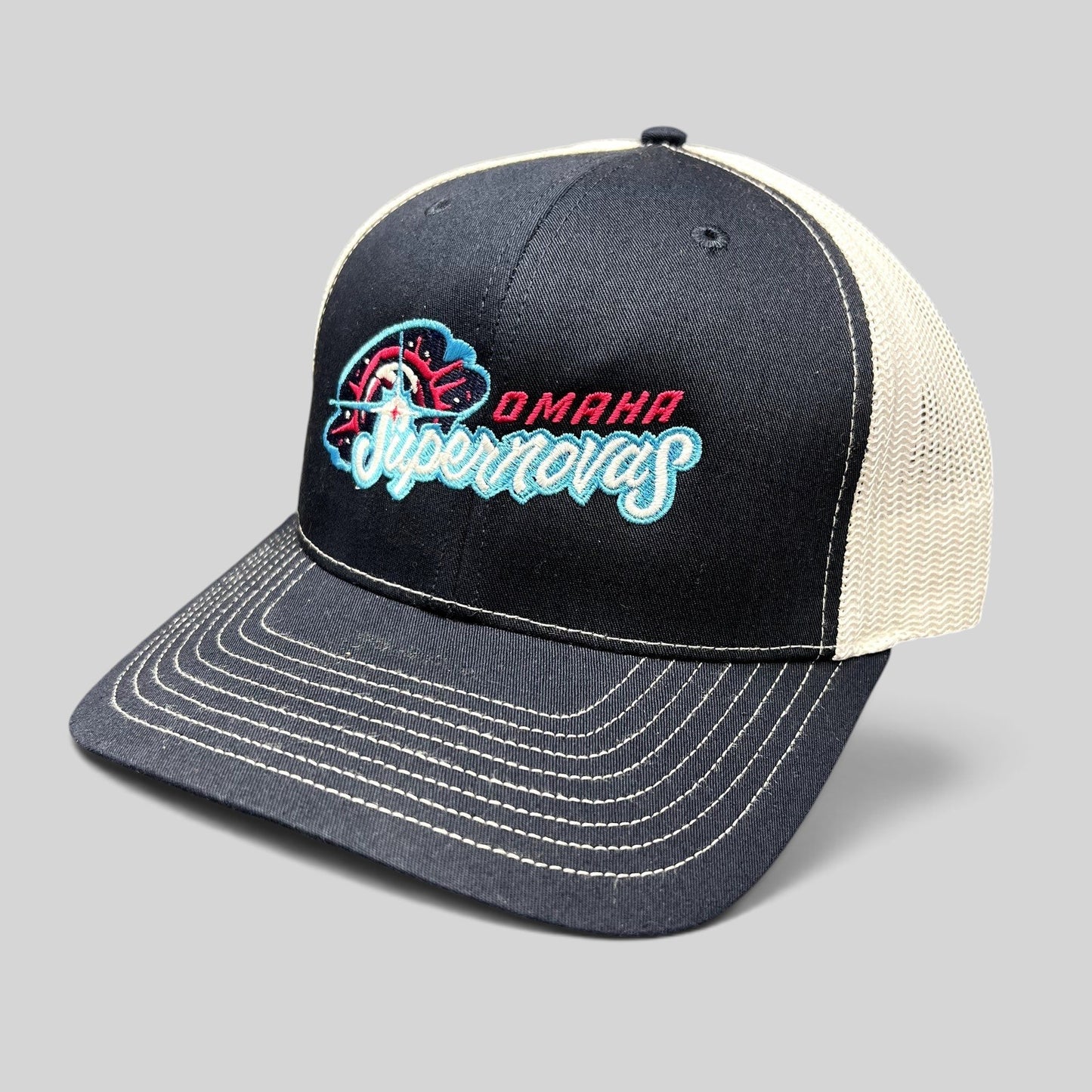 Raree Finds Omaha Supernovas Richardson 112 navy and white trucker hat with teal and pink embroidered logo