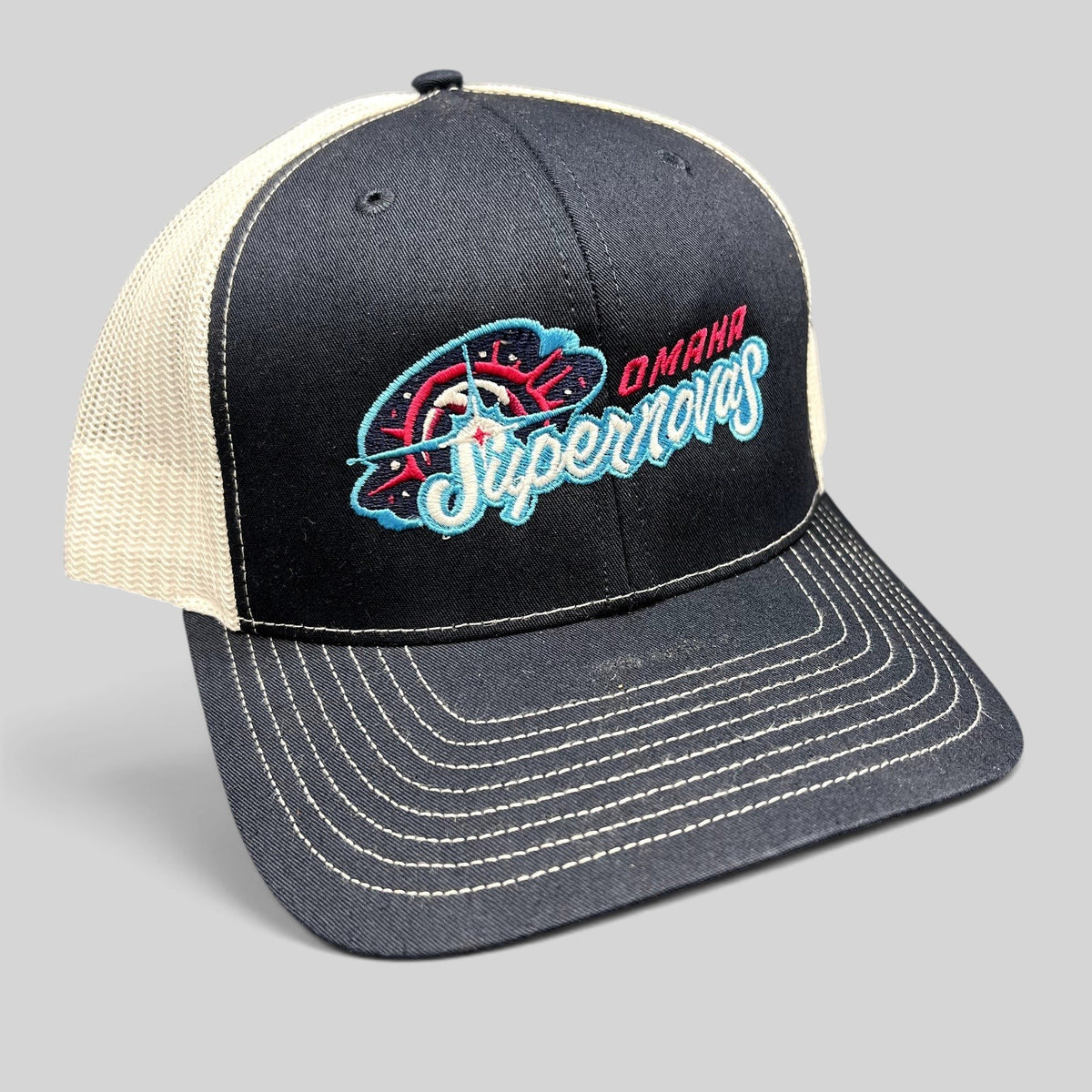 Raree Finds Omaha Supernovas Richardson 112 navy and white trucker hat with teal and pink embroidered logo
