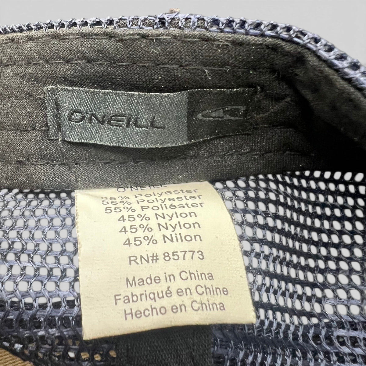 Raree Finds O’Neill trucker hat interior label showing polyester and nylon material composition and brand tag