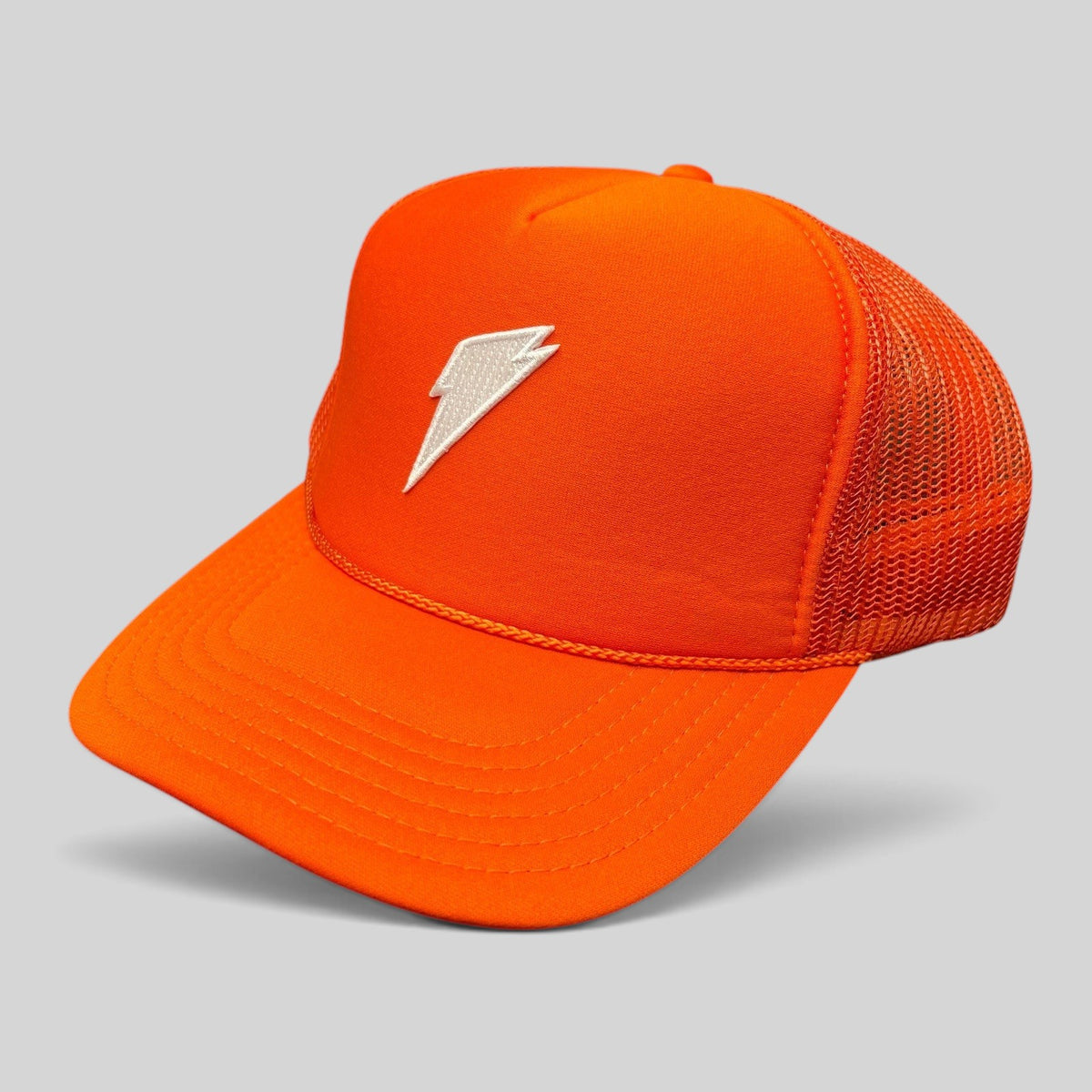 Raree Finds bright orange OTTO trucker hat with a white embroidered lightning bolt logo and breathable mesh back.