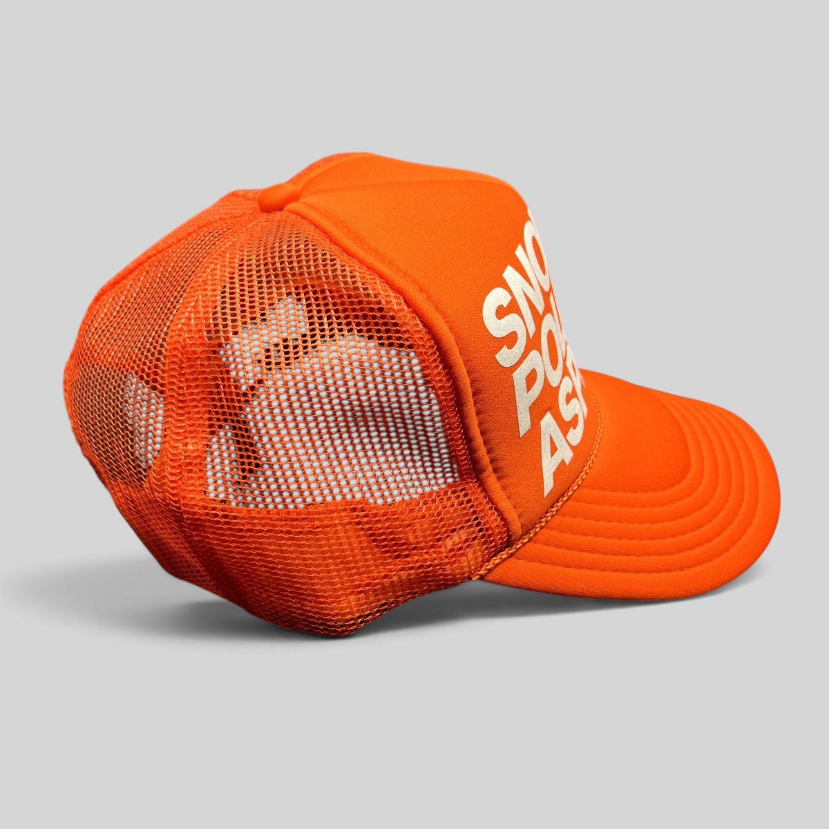 Raree Finds bright orange Snow Polo Aspen trucker hat with white graphic lettering and breathable mesh back panel.
