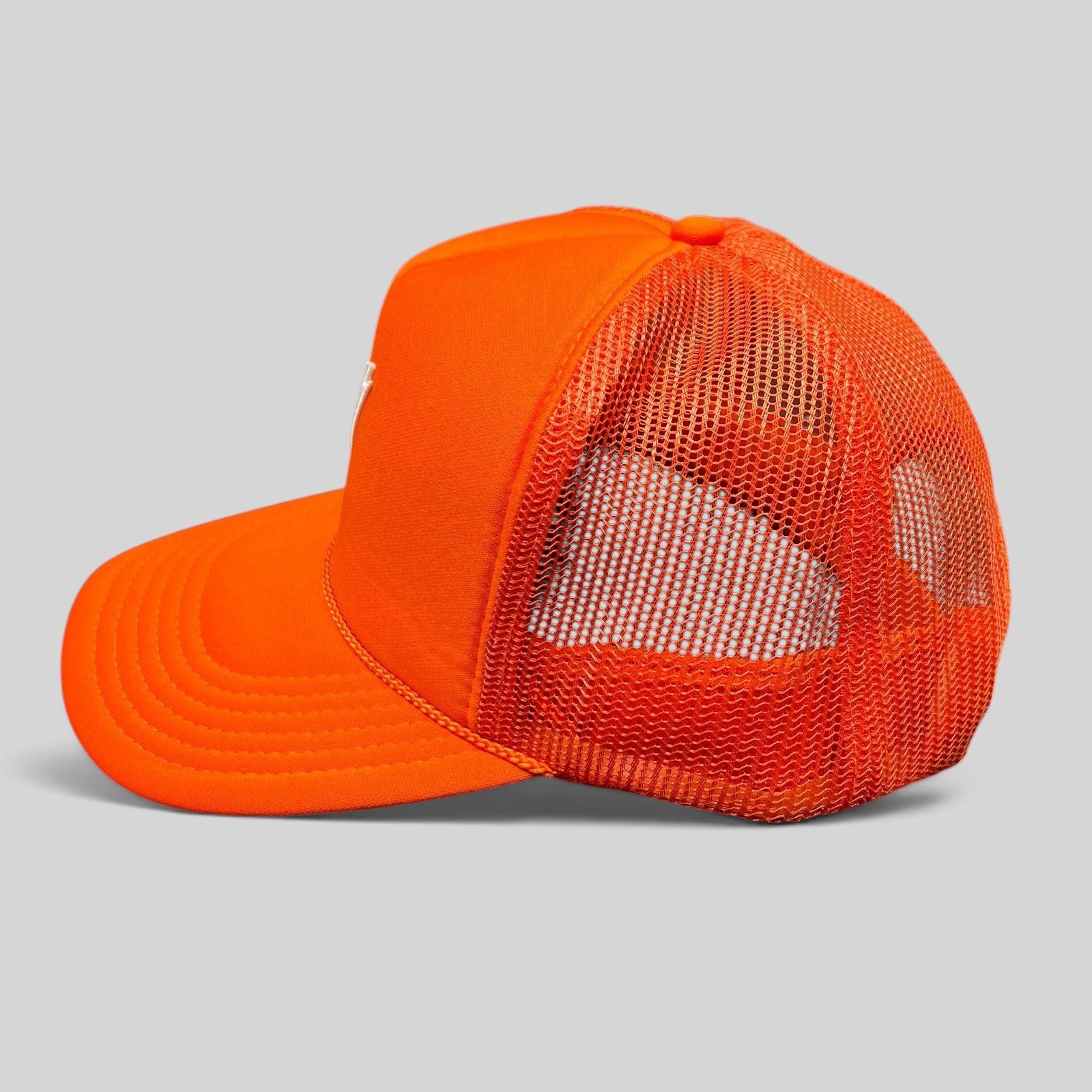 Raree Finds bright orange OTTO trucker hat with mesh back panels and structured foam front, side profile view