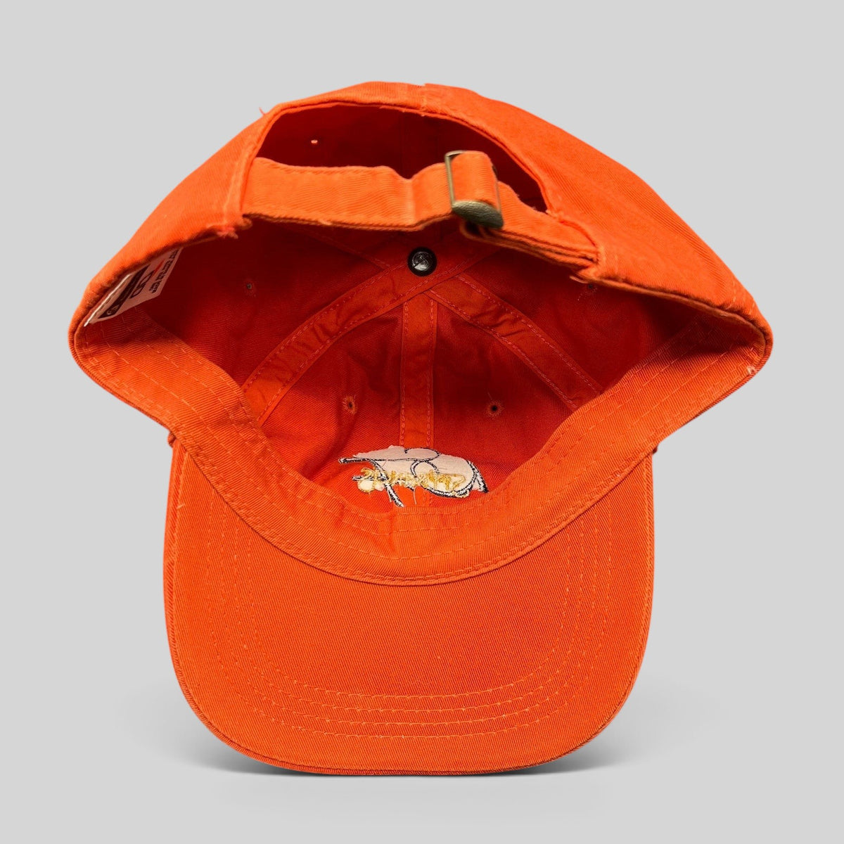 Raree Finds vintage orange cotton strapback hat with adjustable metal buckle and interior script logo embroidery