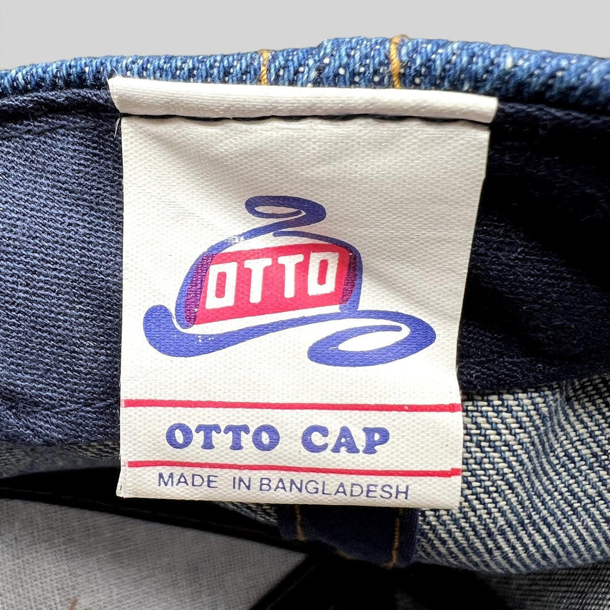 Raree Finds vintage Otto Cap brand label sewn inside a dark indigo denim hat with visible stitching