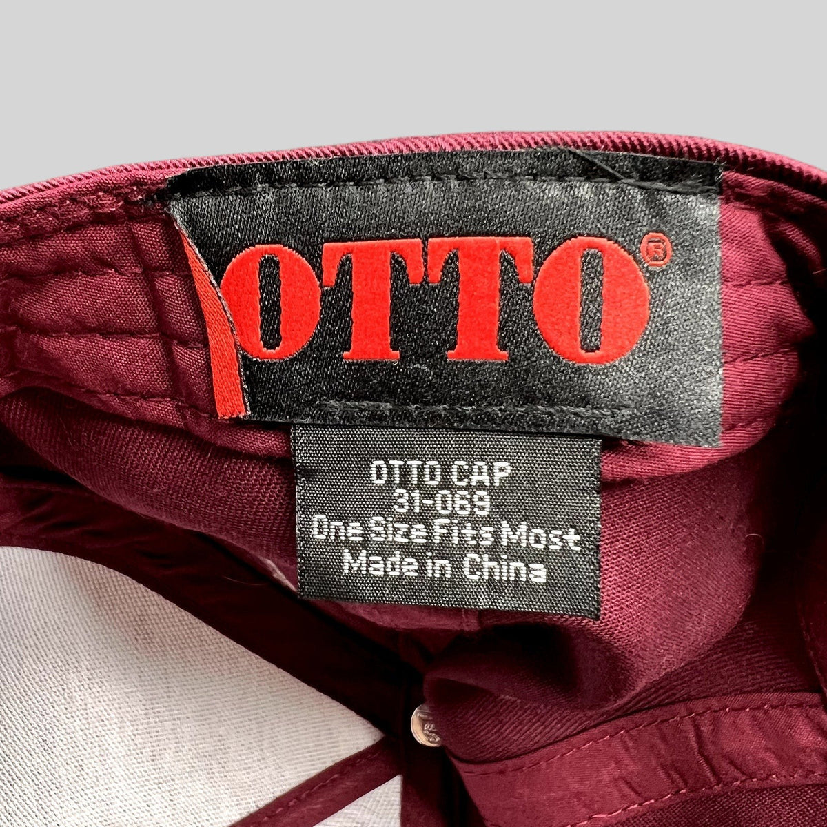 Raree Finds burgundy Otto Cap interior tag showing brand logo and style number 31-069 inside the snapback hat