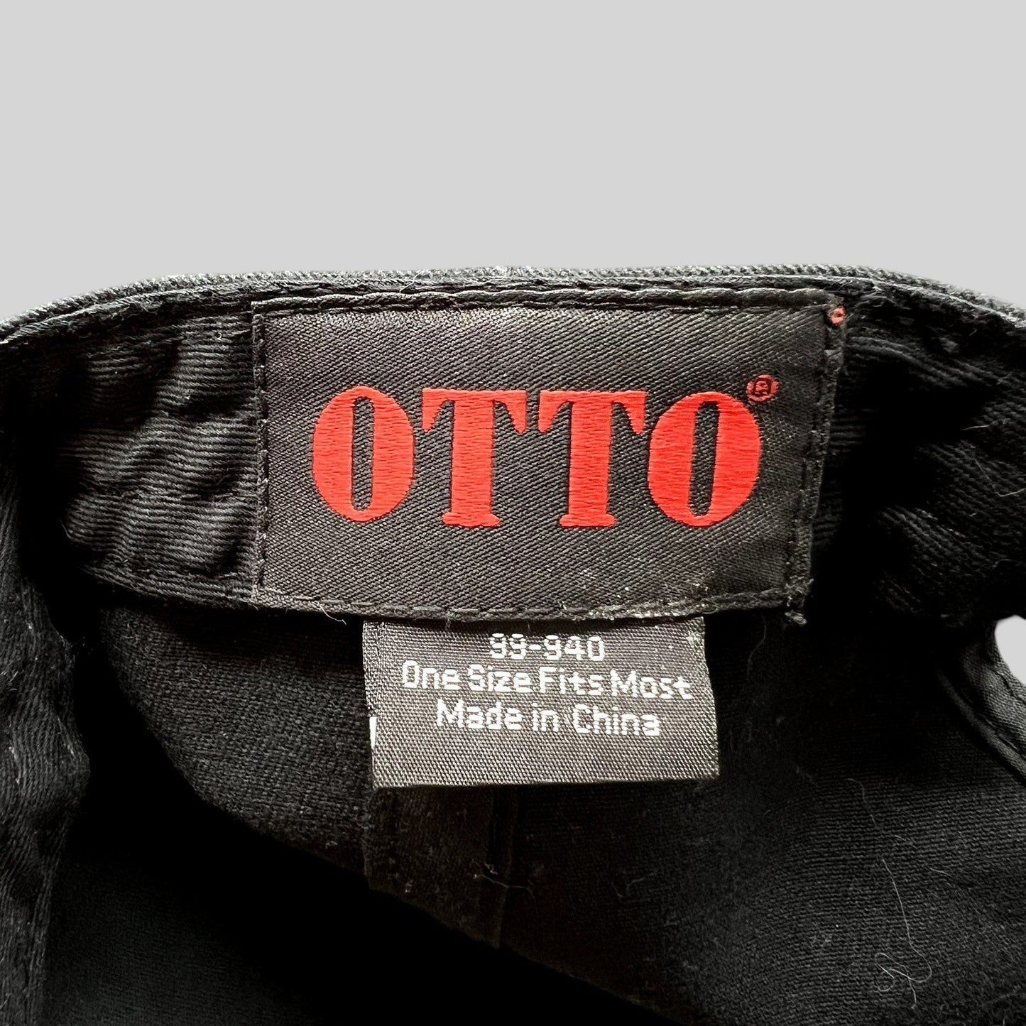 Raree Finds black Otto cap interior label showing brand logo and size information