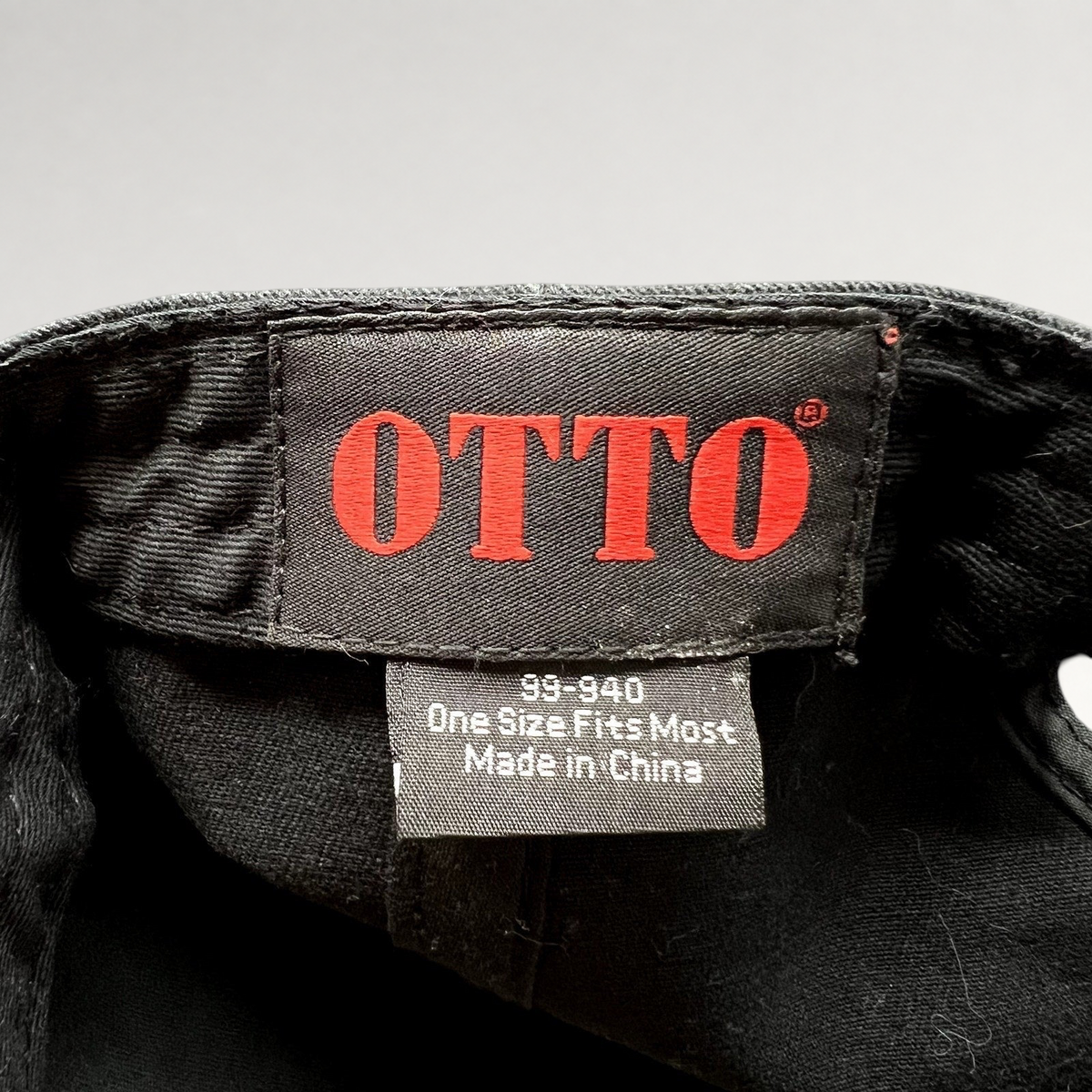 Raree Finds black Otto cap interior label showing brand logo and size information