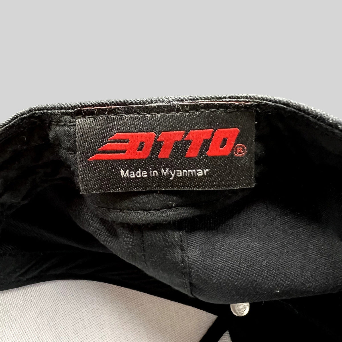 Raree Finds black Otto Cap interior label with red logo and Made in Myanmar text inside a snapback hat