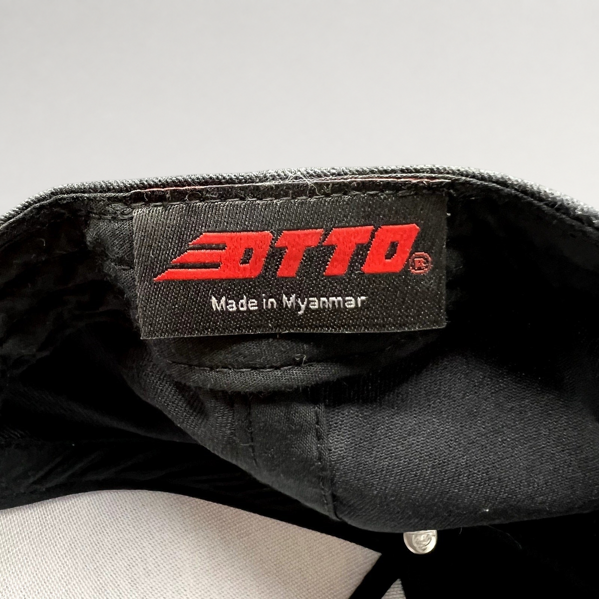 Raree Finds black Otto Cap interior label with red logo and Made in Myanmar text inside a snapback hat