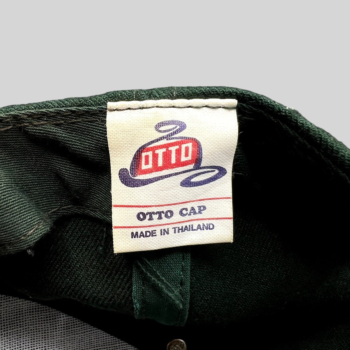 Raree Finds vintage Otto Cap label inside a dark green snapback hat, made in Thailand.