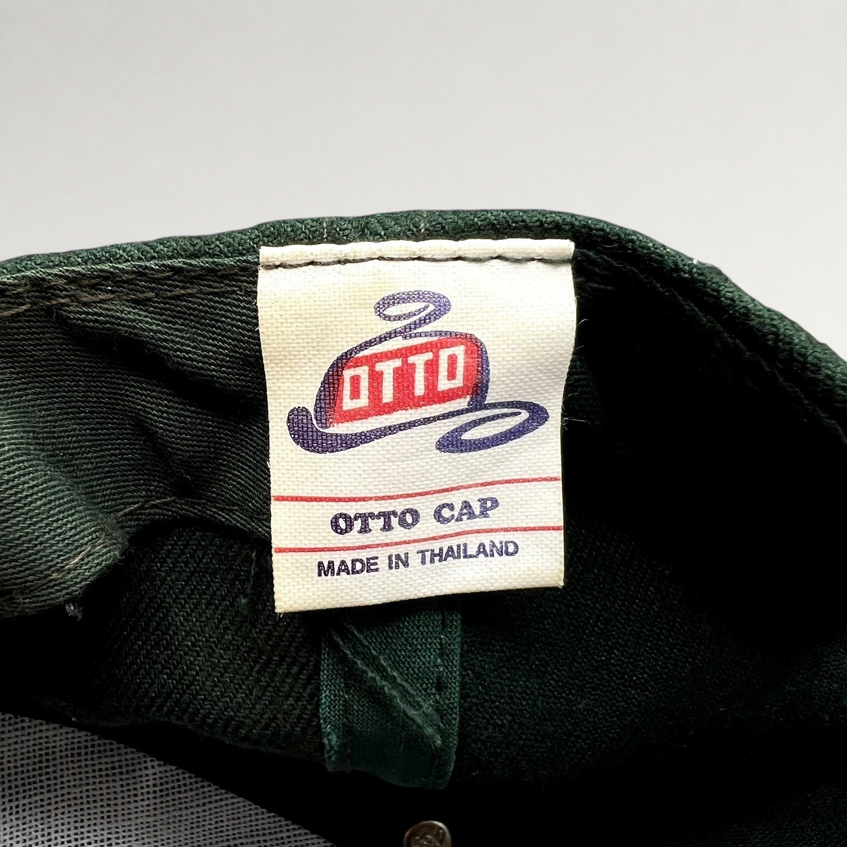 Raree Finds vintage Otto Cap label inside a dark green snapback hat, made in Thailand.