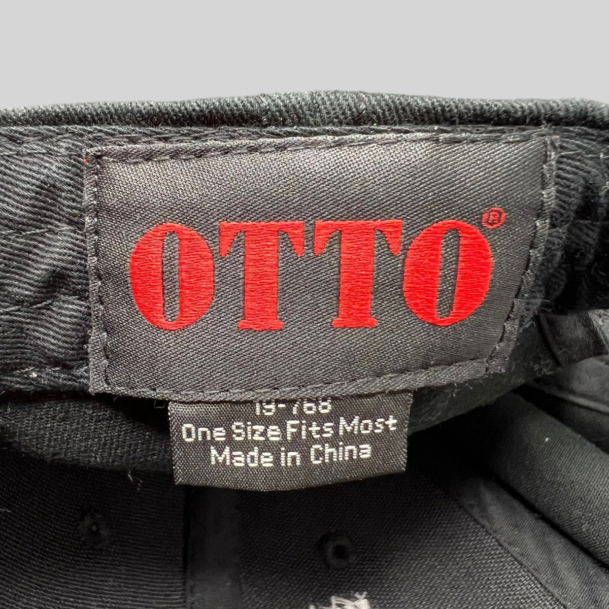 Raree Finds vintage OTTO Cap interior label with red logo text and size information on a black cotton snapback hat