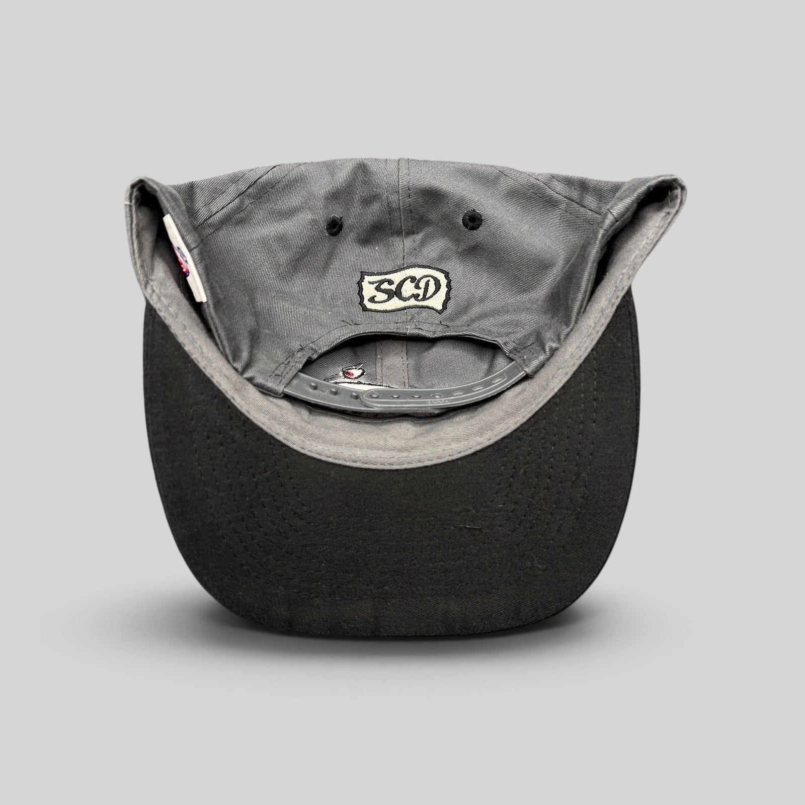 Raree Finds vintage Otto Cap snapback showing the SCD embroidered patch on the gray cotton twill back panel