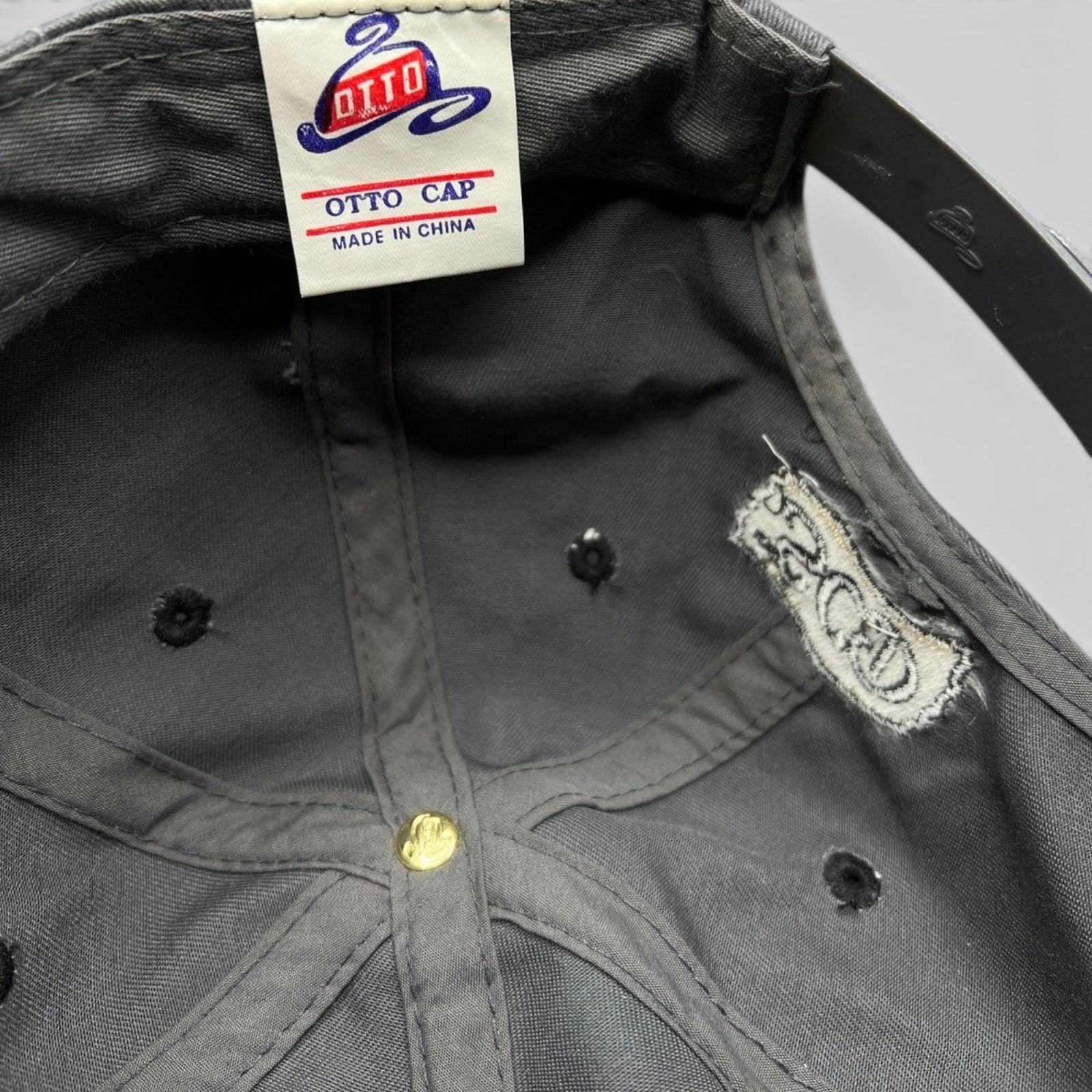 Raree Finds vintage Otto Cap snapback interior showing the brand label and SCD embroidery on the gray cotton lining.