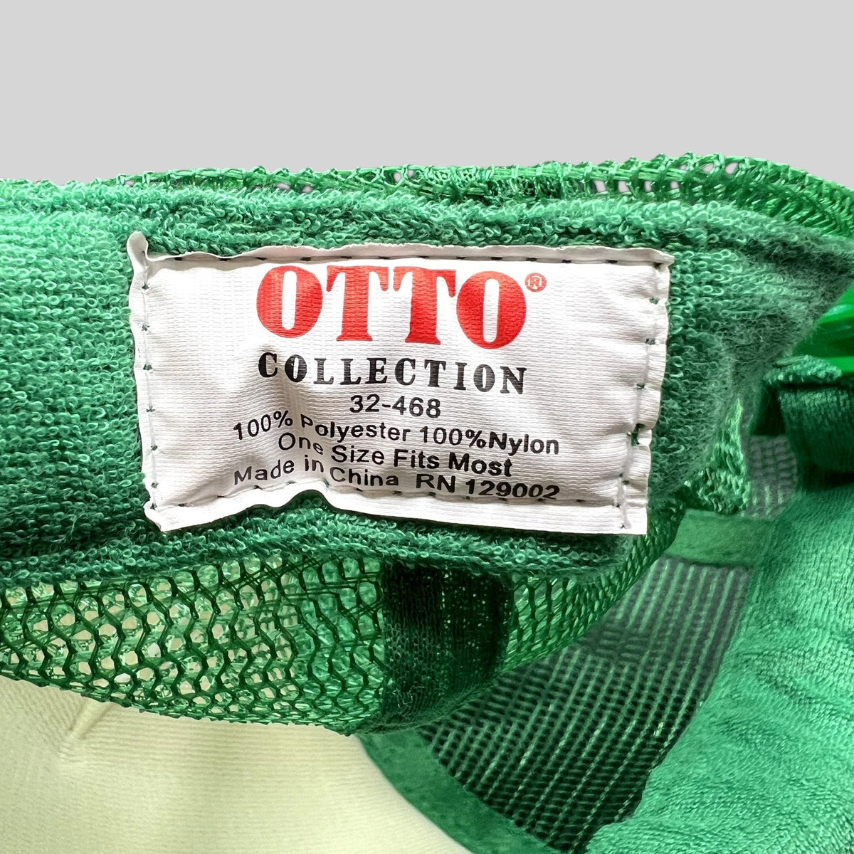 Raree Finds OTTO Collection trucker hat interior tag showing polyester and nylon material composition