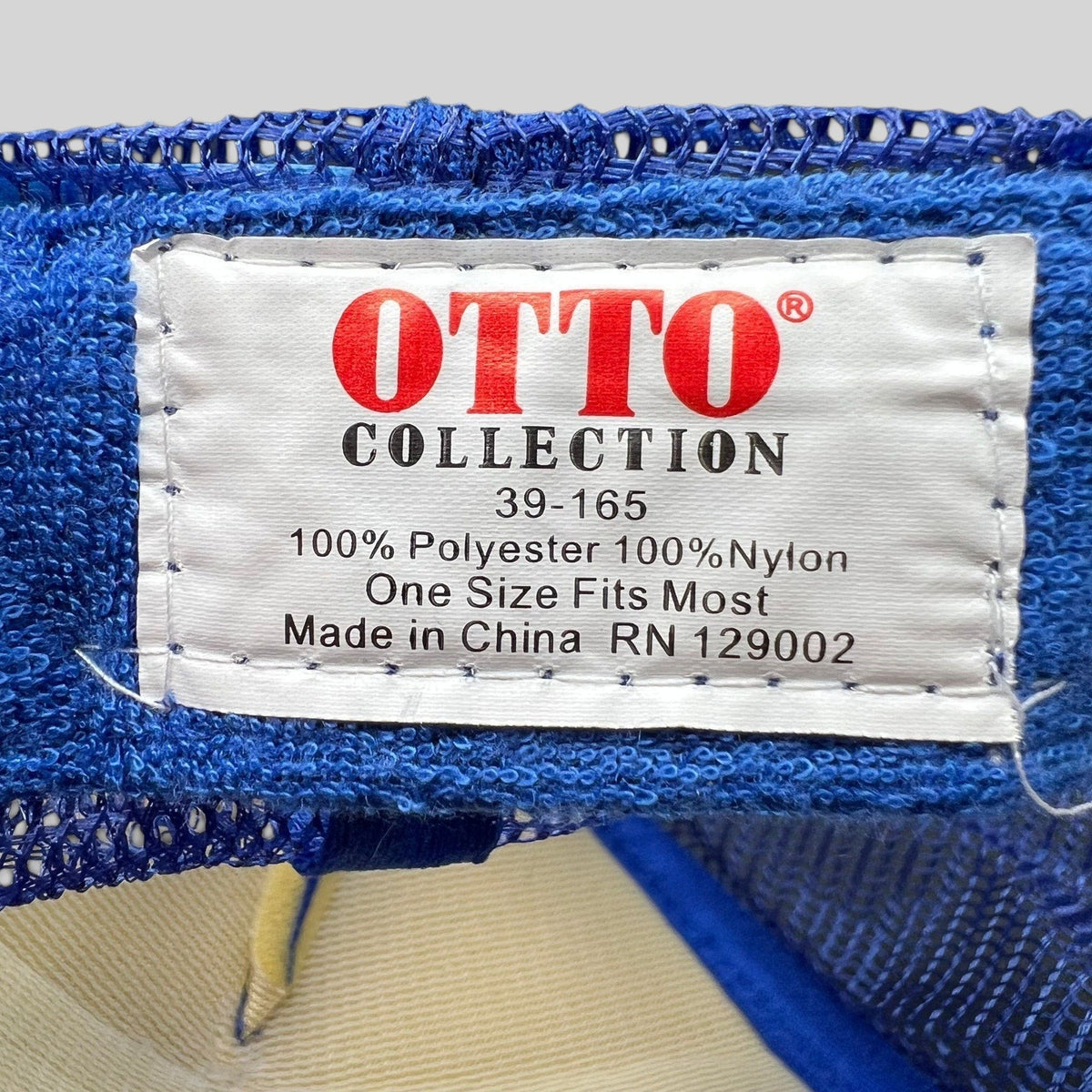 Raree Finds vintage Otto Collection trucker hat interior tag showing polyester and nylon material composition