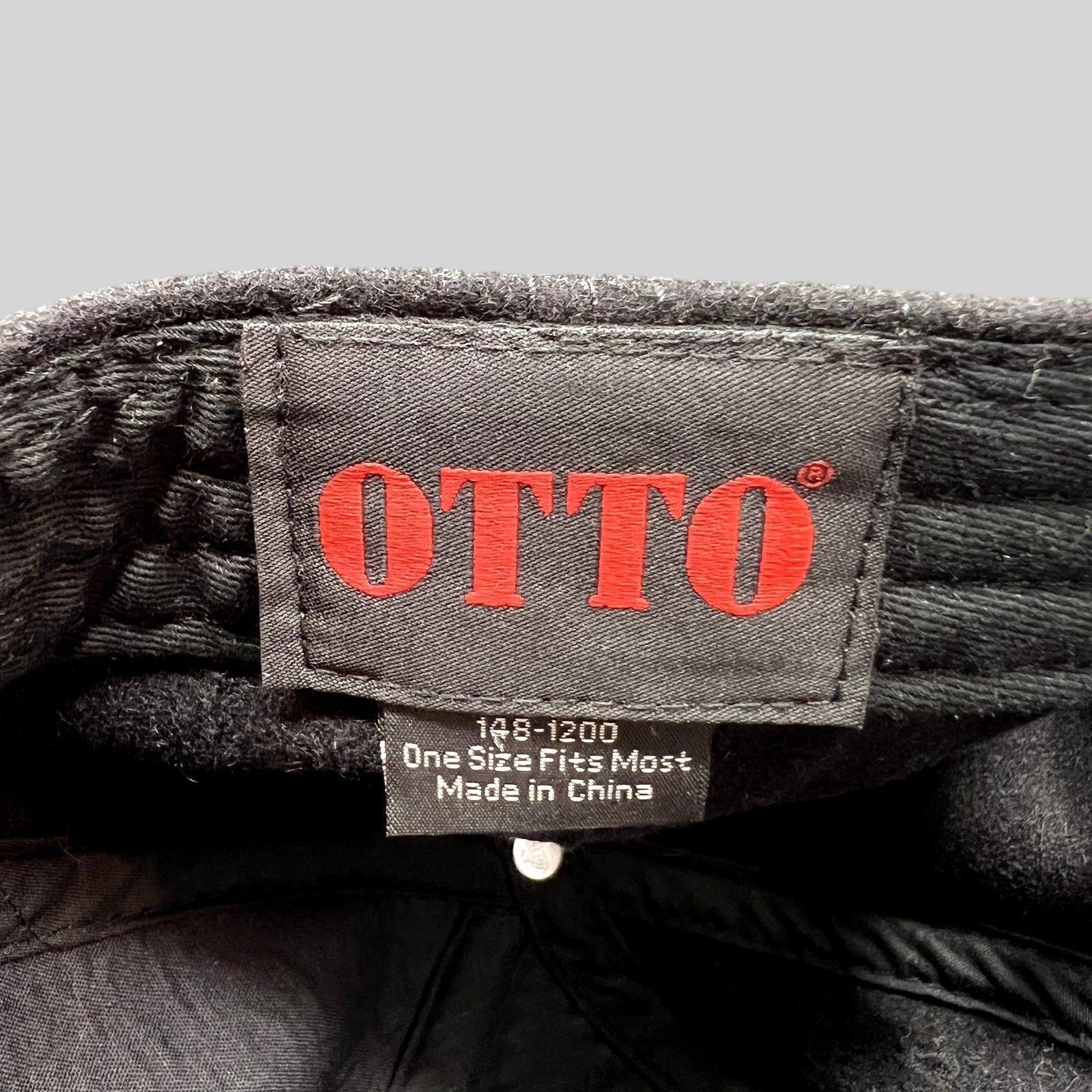 Raree Finds Otto brand label inside a black wool blend Ikon Pass strapback hat with size and origin information.