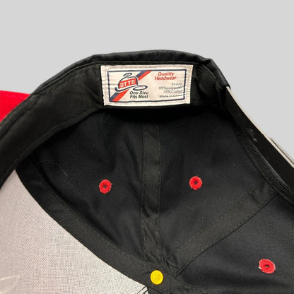Raree Finds Otto snapback hat interior showing the brand label and red ventilation eyelets on a black crown