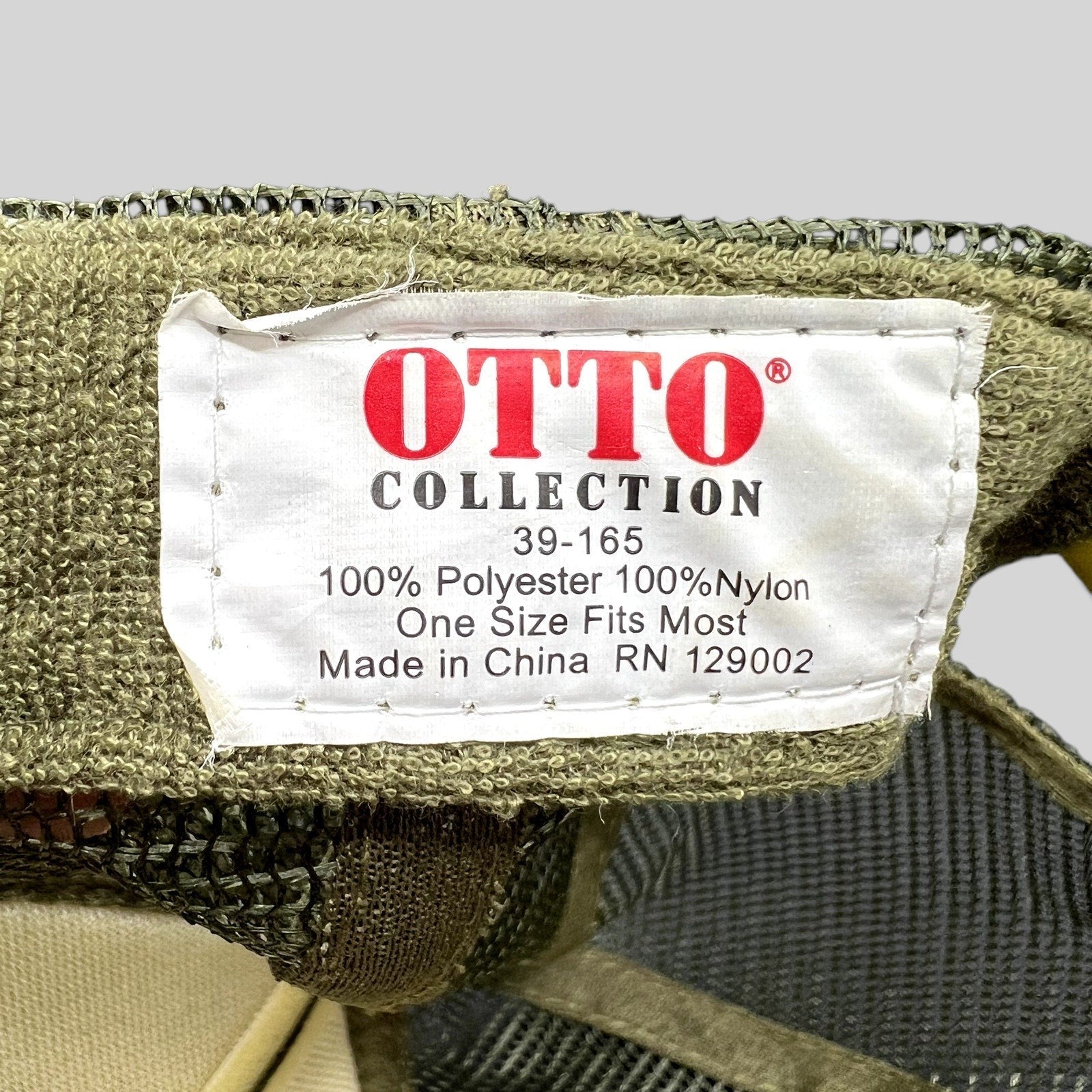 Raree Finds OTTO Collection trucker hat interior tag showing polyester and nylon material details in olive green