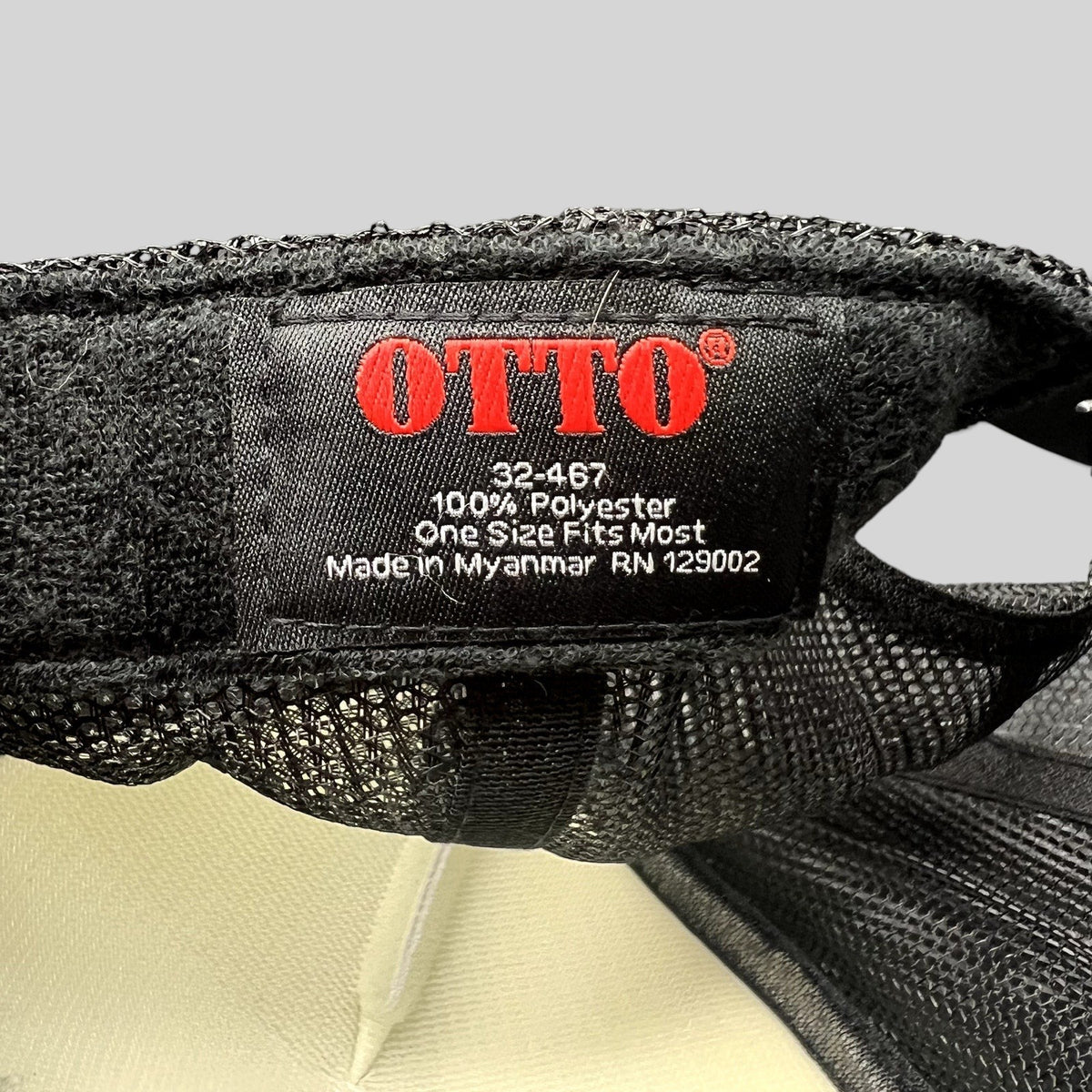 Raree Finds Otto trucker hat interior tag showing 100 percent polyester material and made in Myanmar details