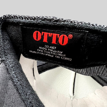 Raree Finds Otto trucker hat interior tag showing brand logo, 100% polyester material, and manufacturing details.