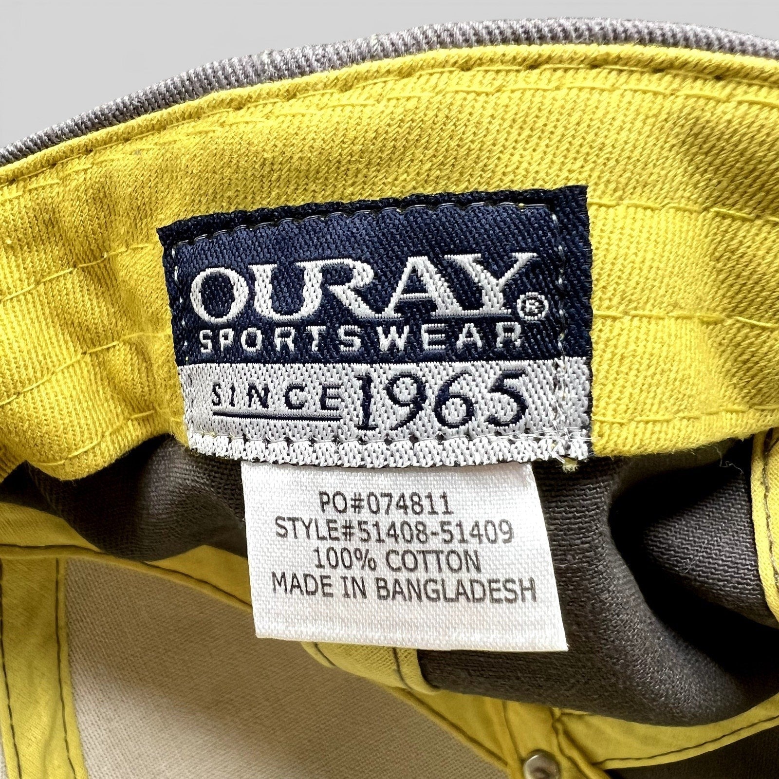 Raree Finds Yellowstone Brewing Co hat interior label showing Ouray Sportswear branding and 100% cotton material tag