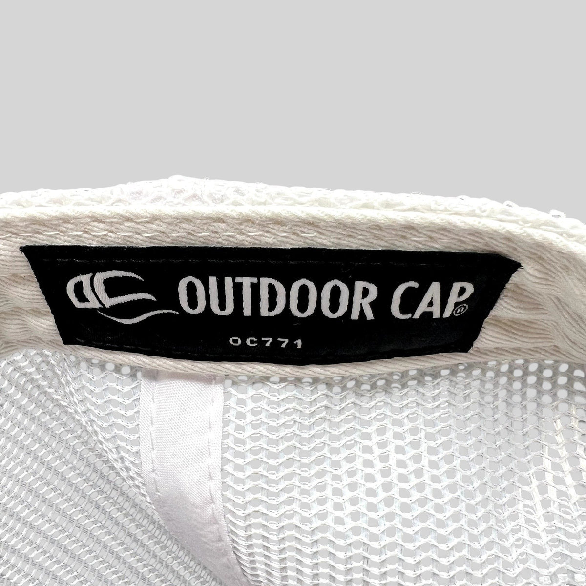 Raree Finds interior label of an Outdoor Cap OC771 trucker hat with white mesh lining